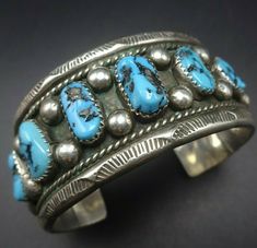 "VINTAGE NAVAJO BRACELET DESCRIPTION: This stunning bracelet features high blue Kingman turquoise and hand applied stamp work on the edges. This classic bracelet will be a cherished addition to your collection of fine vintage Native American jewelry. MEASUREMENTS: Interior of the cuff measures 5 1/4\" with an additional 1 1/4\" non-adjustable gap. Total circumference: 6 1/2\" Measures 2 1/8\" straight across the widest part (from wrist bone to wrist bone) Bracelet face measures 1\" wide (the fac Classic Handmade Turquoise Bracelets, Southwestern Style Stamped Blue Bracelets, Bohemian Stamped Blue Bracelets, Blue Stamped Bohemian Bracelets, Bohemian Blue Stamped Bracelets, Southwestern Blue Cuff Jewelry, Vintage Stamped Blue Jewelry, Blue Vintage Stamped Jewelry, Classic Turquoise Cuff Bracelet Gift