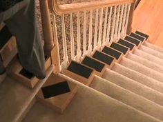 someone is walking down the stairs with their feet on the carpeted stair treads