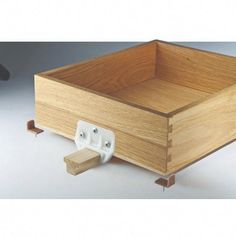 a wooden box with two white handles on the bottom and one in the middle that is attached to it