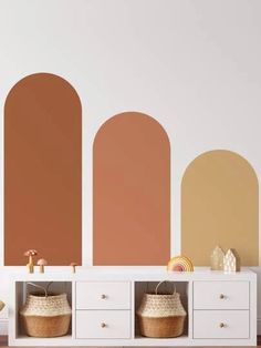 an empty room with three different color walls and baskets on the shelf next to it