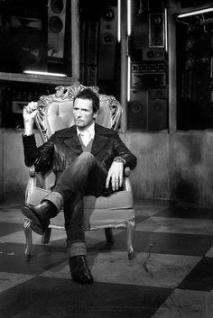 black and white photograph of a man sitting in a chair