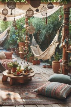 an outdoor living area with hammocks and pillows