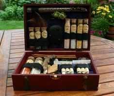 an open suitcase sitting on top of a wooden table filled with spices and condiments