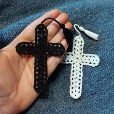 a crocheted cross being held in someone's hand