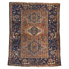 an antique rug with blue, orange and brown colors on the bottom half of it