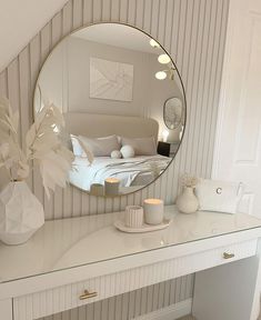 a mirror sitting on top of a white desk