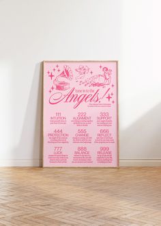 a pink poster on the wall in an empty room with wood flooring and white walls