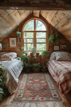 two beds in a small room with a rug on the floor and windows above them