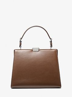 The epitome of polished glamour. The Simone satchel is crafted in Italy from rich calf leather in a structured top-handle silhouette with understated hardware. Carry it against both day and evening ensembles for a ladylike finish. Structured Top, Leather Satchel Bag, Michael Kors Collection, Leather Silver, Leather Satchel, Satchel Bags, Top Handle, Calf Leather, Zip Pockets