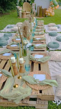 a table set up with plates, candles and napkins for an outdoor dinner party