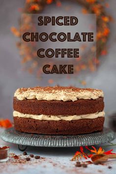 a chocolate cake with frosting on top and the words spiced chocolate coffee cake above it