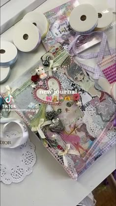 a table topped with lots of different types of crafting supplies on top of it