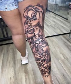 a woman's leg with some tattoos on it