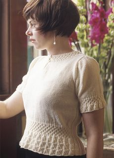 a woman standing next to a window with flowers in the background