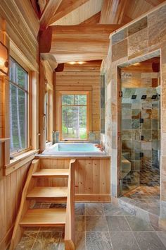 a bathroom with a large jacuzzi tub next to a walk in shower