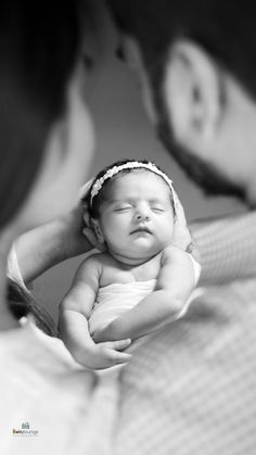 a man holding a baby in his arms