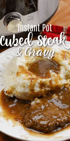 instant pot cubed steak and gravy on a plate next to an electric pressure cooker