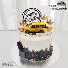 a birthday cake decorated with a school bus and gold crown on top is sitting on a table