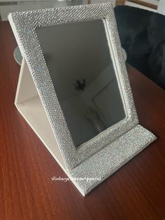 a mirror sitting on top of a wooden table