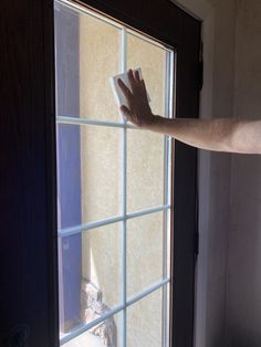 a person is cleaning the window with a cloth on it's arm and hand