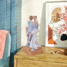 a figurine is sitting on a dresser next to a painting