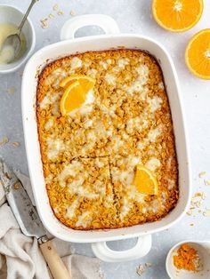 a casserole dish filled with oranges and crumbled oatmeal