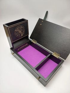 an open black box with purple paper inside