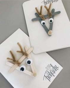 two handmade reindeers made out of construction paper with googly eyes on them