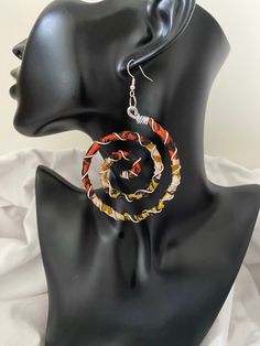 African fabric swirls communicating confidence and strength.  Wrapped with aluminium to add a touch of style. Be noticed! Let the swirls do the talking!   Sterling silver earring hooks for sensitive earring wearers. To maintain wash sterling silver earring hooks in soapy warm water, clean and dry with a soft cloth and the silver colour will be restored. Diameter 7cm Spirals symbolises innocence, growth and energy Handmade with love and care The Benefits of Aluminium Jewellery 1.Super light weight 2.It is hypoallergenic due to not containing Nickel 3.It doesn't rust 4.It doesn't tarnish 5.Easy to clean, if needed wash in soapy water Name of earrings 'African Swirl' African Earrings Handmade Inspire Uplift ⭐, African Earrings Handmade Afrikrea.com, Earrings Handmade Fabric Earrings Handmade, Shredded Fabric Earrings, Fabric Jewellery Handmade Tutorial, Swirl-shaped Earrings With Ear Wire, African Fabric Accessories, Afrocentric Accessories, Ankara Earrings