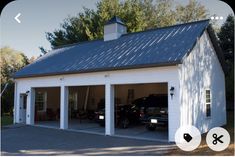 a garage with two cars parked in front of it and another car on the other side