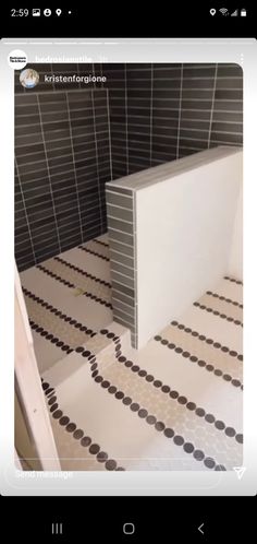 a bathroom with black and white tiles on the floor