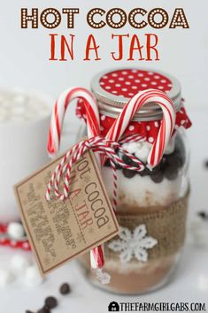 hot cocoa in a jar with candy canes and marshmallows on top