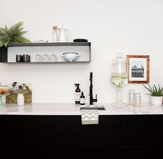 the kitchen counter is clean and ready to be used as a shelf for bottles, glasses, and other items