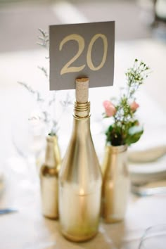 an image of a table setting with wine bottles and place cards on the top one