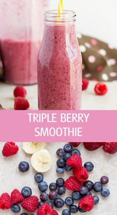 a smoothie in a mason jar with strawberries and blueberries