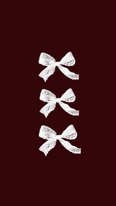 three white bows on a black background