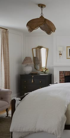 a bedroom with a bed, dresser and mirror in it's centerpieces