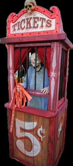 an old fashioned ticket booth with a skeleton in it