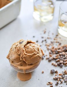 a scoop of ice cream sitting on top of a table next to some chocolate chips