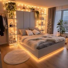 a bedroom with lights on the walls and a large bed in front of a window