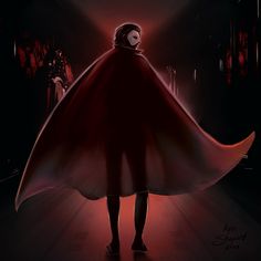 a woman in a red cape walking down a dark hallway