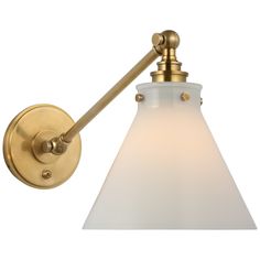 a brass wall light with a white glass shade