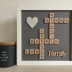 a framed scrabble art piece with the words family and a heart on it