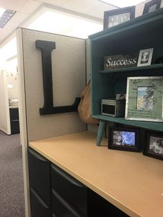 an office cubicle with shelves and pictures on the wall