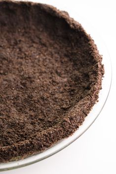 a chocolate cake sitting on top of a glass plate covered in brown sugar and crumbs