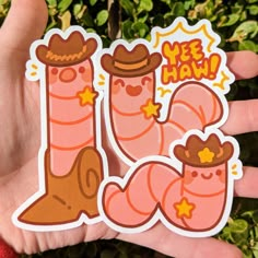 a hand holding up a sticker that says weee haw