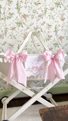 a white baby carriage with pink bows and a card on the back that says hello kitty