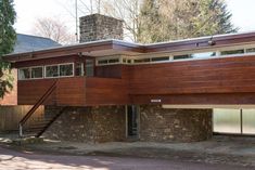 a large wooden house sitting on top of a hill