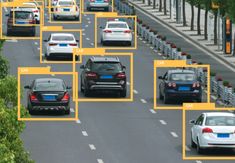 many cars are driving down the road with yellow arrows pointing in different directions to each other