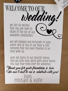 a wedding welcome card is hanging on the wall